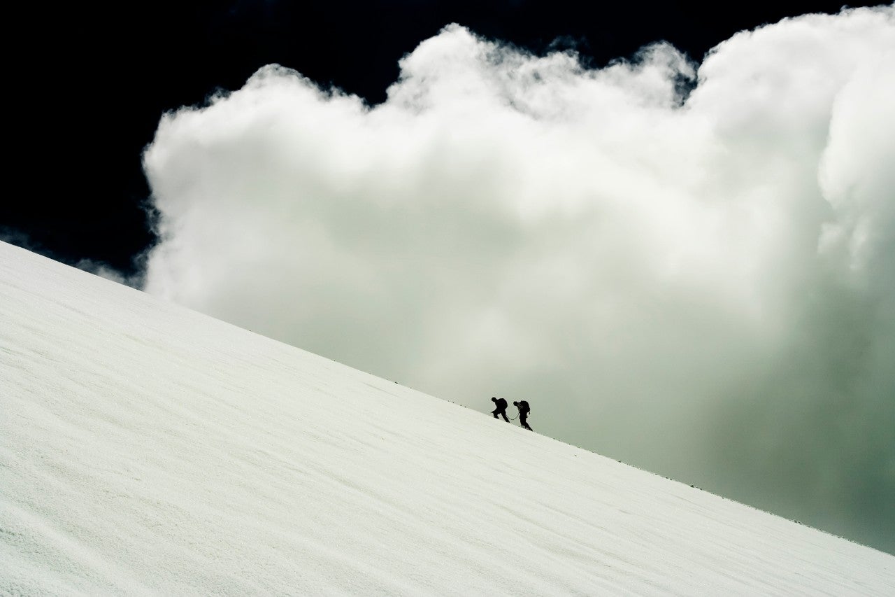 ws_climbers_on_snowy_hill_with_clouds
