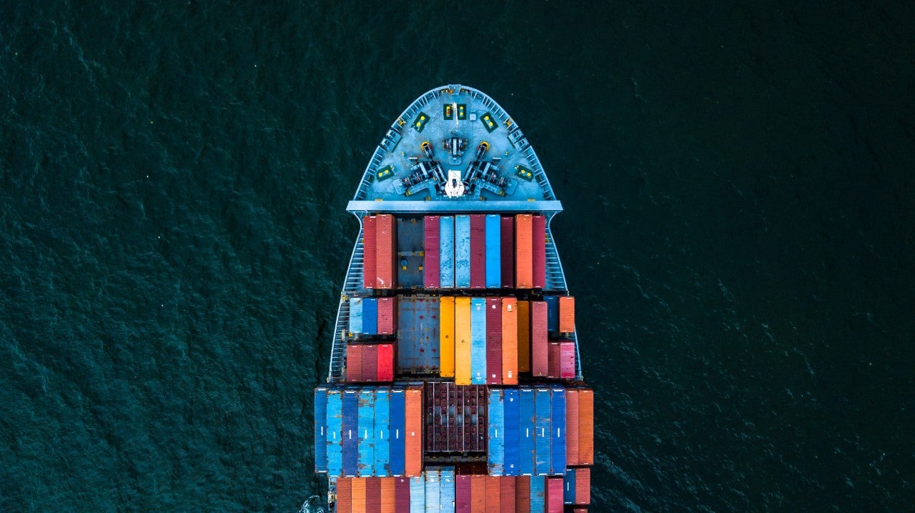 ws_colourful_container_ship_on_dark_sea