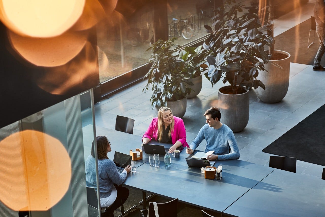 withsecure employees at a conference desk on laptops withsecure employees at a conference desk on laptops