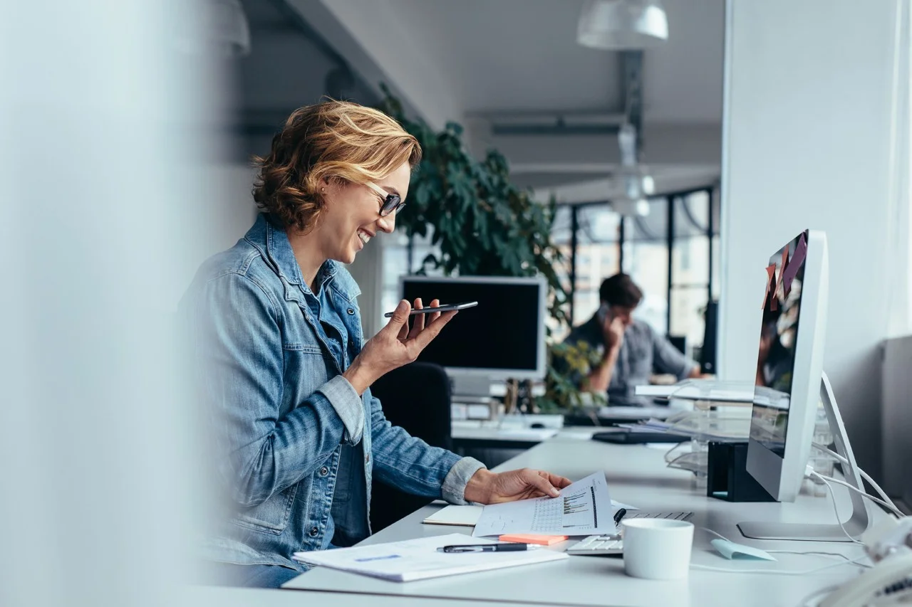 ws_businesswoman_talking_on_smartphone_and_looking_at_documents_hero