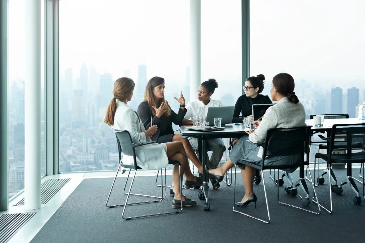 Business people in large modern meeting room